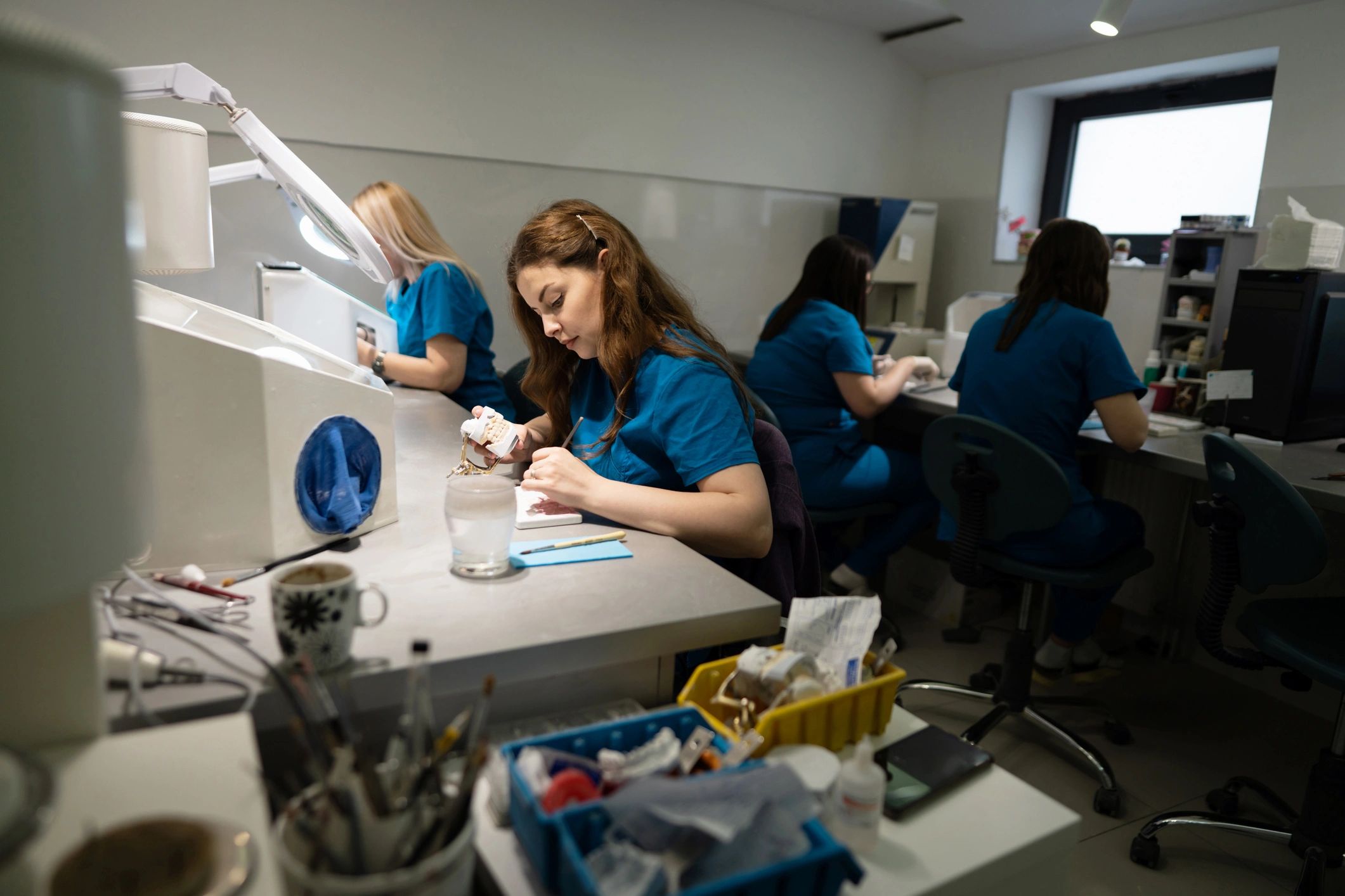 Students working in a dental laboratory setting